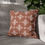 Thumbnail: Square throw pillow with white geometric patterns on a terracotta background, ideal for boho and modern home decor.