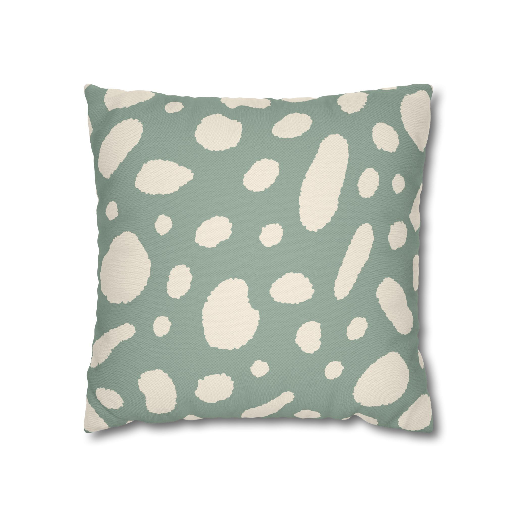 Pillow cover with an abstract cream spot pattern on a muted sage green background, offering a playful yet modern design.