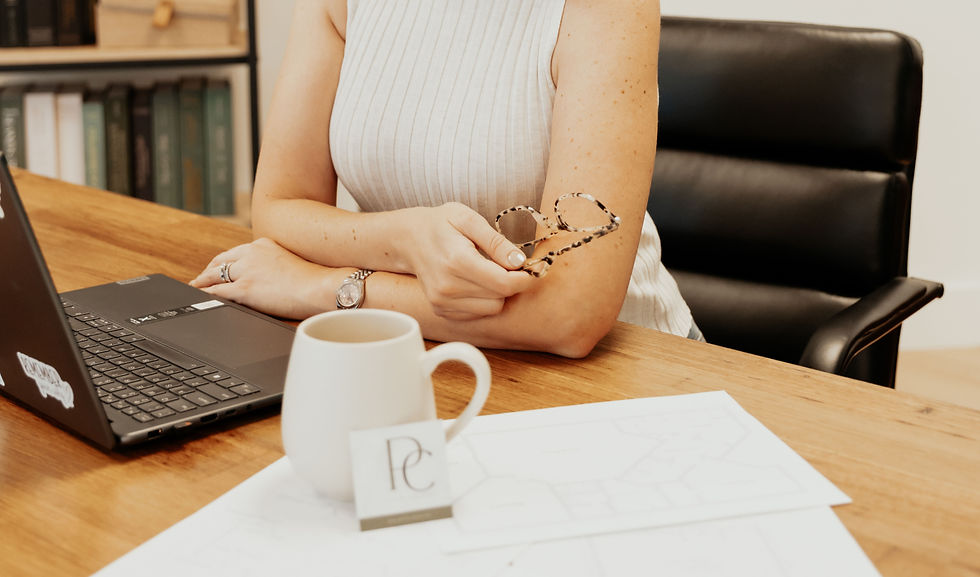 Sarah Pence, owner & lead designer at Pence Creative, sitting at her desk.