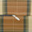 Thumbnail: Lumbar cushion with heritage plaid pattern in golden yellow, chestnut brown, beige, and forest green tones.