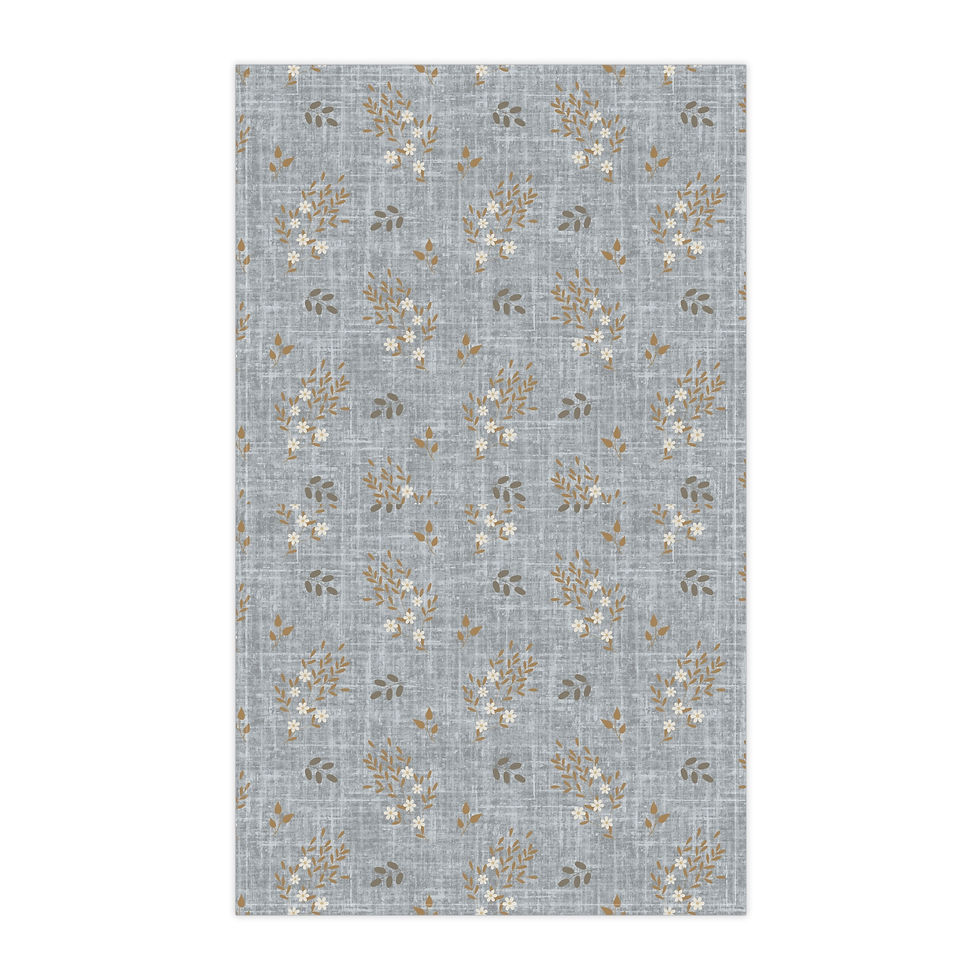 Dusty blue tea towel with beige and white floral clusters and soft brown leaves in a vintage botanical design.