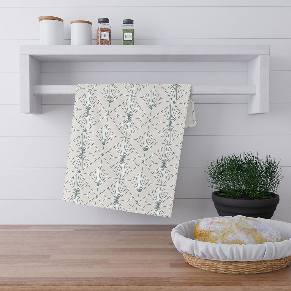 Tea towel with an elegant art deco geometric fan pattern in soft gray on a cream background, hanging in a modern kitchen.