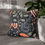 Thumbnail: Black pillow cover with bright illustrated leaves and berries in shades of orange, olive green, blush, and charcoal, arranged