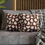 Thumbnail: Pillow cover with a playful pattern of white ghosts on a brown background.