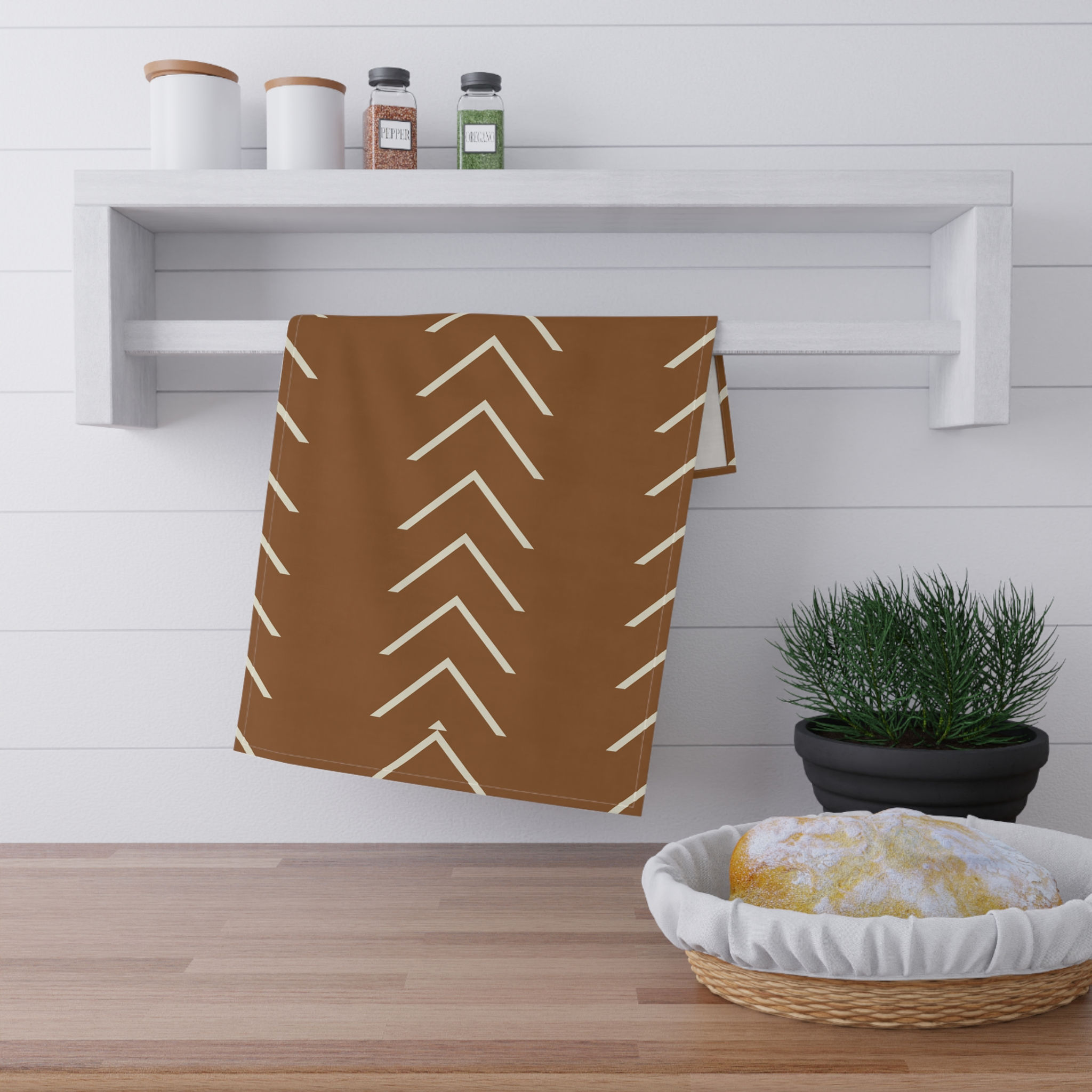 Clay-colored tea towel with cream chevron arrow pattern in a modern geometric design