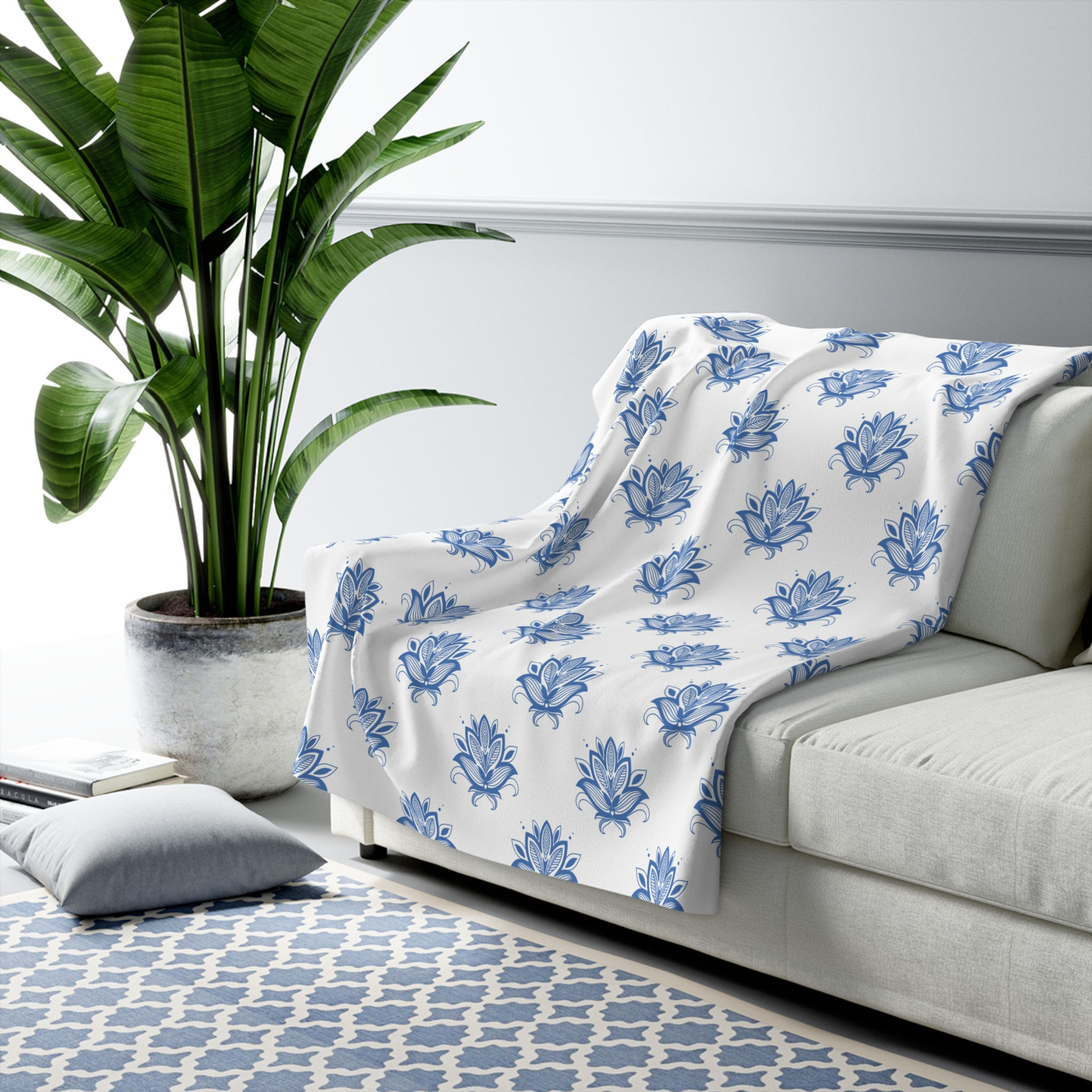 Sherpa blanket with a repeating blue lotus flower design on a white background.