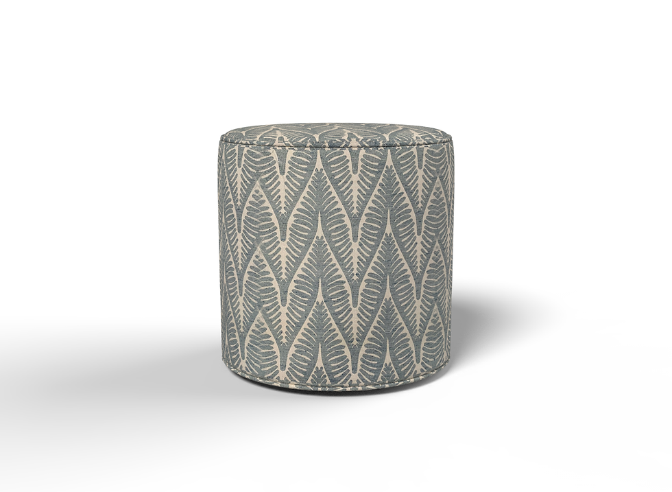 A front view of a cylindrical drum ottoman with a flat top, upholstered in a fabric, designed for use as