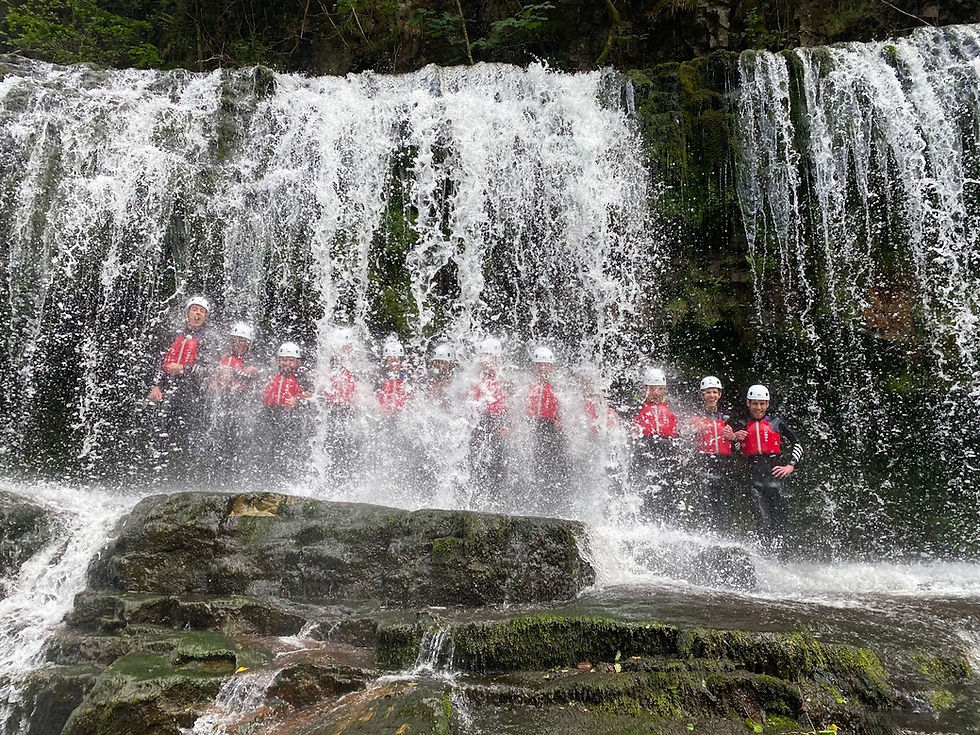 A group having fun Canyoning at Brecon Beacon - Ty Coppi Adventure