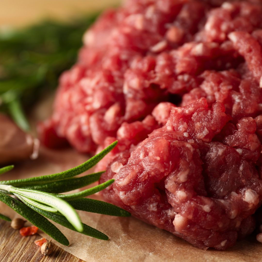 Raw ground beef with rosemary sprig