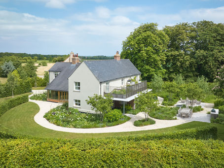 A farmhouse property set within mature gardens