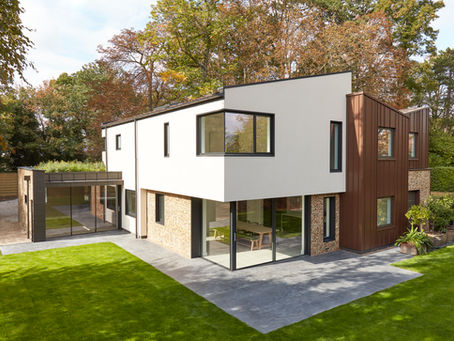 A contemporary home with a green roof planted with wild flowers