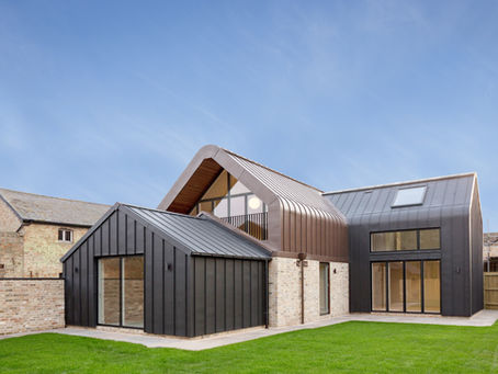 A contemporary family home dropped inside an old barn