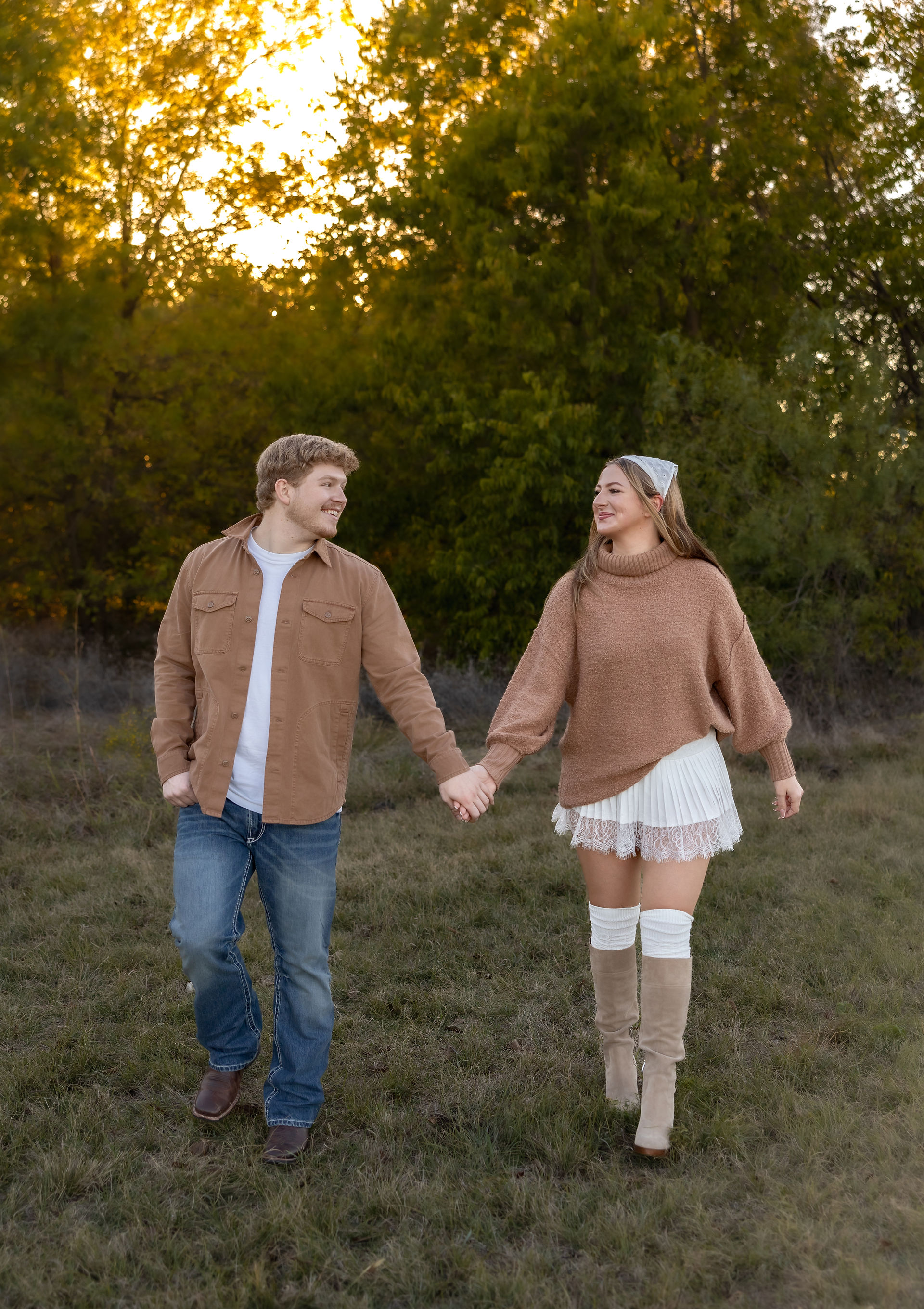 Fall field minis of couple standing in golden back lit field 