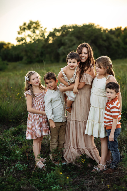Mom with her 5 kids playing at Murrell Park in flower mound during their fall family session with Precious Gems Photography 