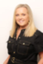 Megan Rose, Founder and CEO of The Connect Agency. Megan is facing the camera and smiling. She has blonde stright hair and wears a black denim jumpsuit. Megan is photographed against a cream coloured background