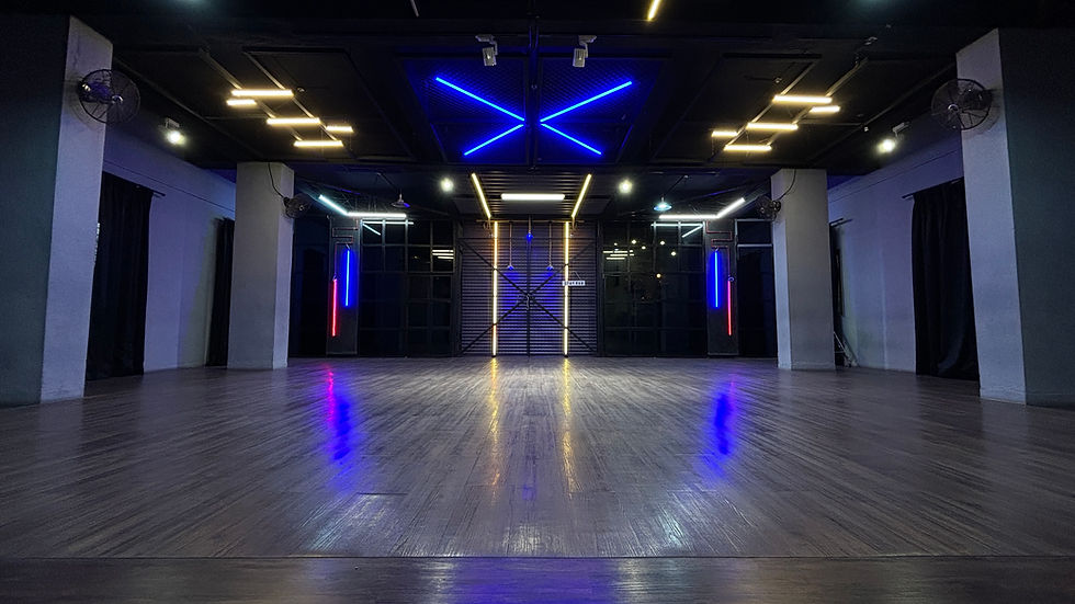 Eye-level view of a spacious dance studio with wooden floors and mirrors