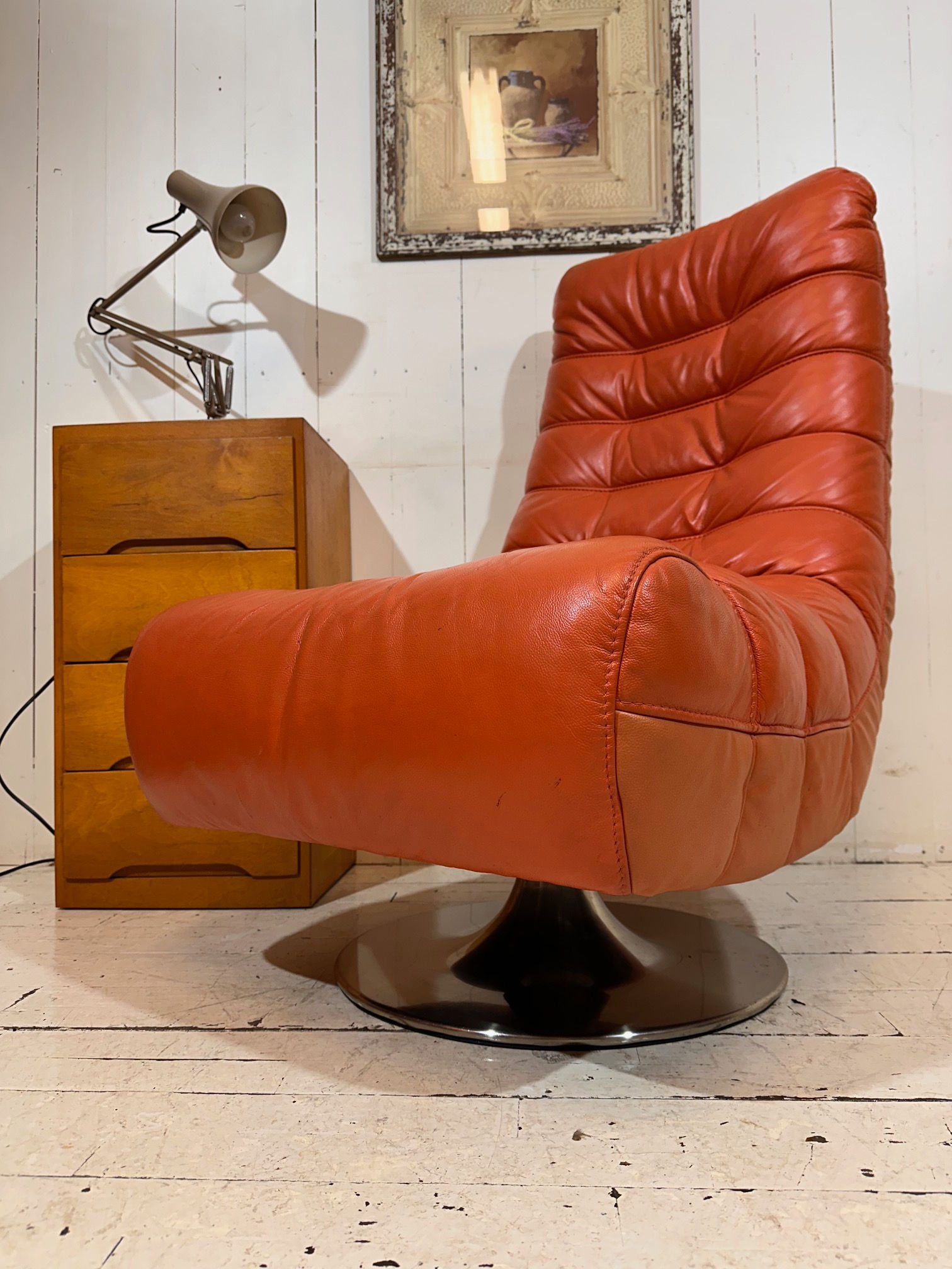 Vibrant orange leather swivel armchair, retro vibes, super comfortable, gaming chair, man cave chair, interior, movie prop,