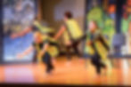 Dancers (wearing construction vests) interpret building a house on a rock. The stage background is decorated with art inspired by parables.