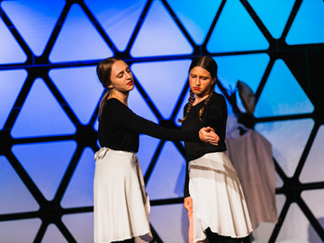 Two actresses in a dramatic scene.