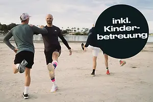 Eine Passstraße schlängelt sich durch die felsigen Berge Mallorcas – im Hintergrund das blaue Mittelmeer