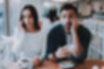 A woman on the phone sitting next to a man