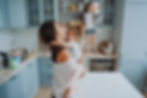 An overwhelmed mom playing with her kids in the kitchen
