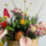 summer exotic flower arrangement in basket