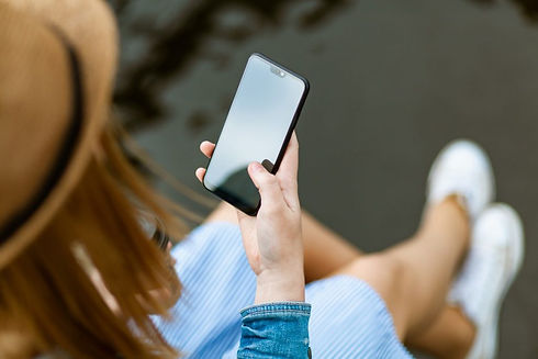 person-holding-smartphone-white-sitting-