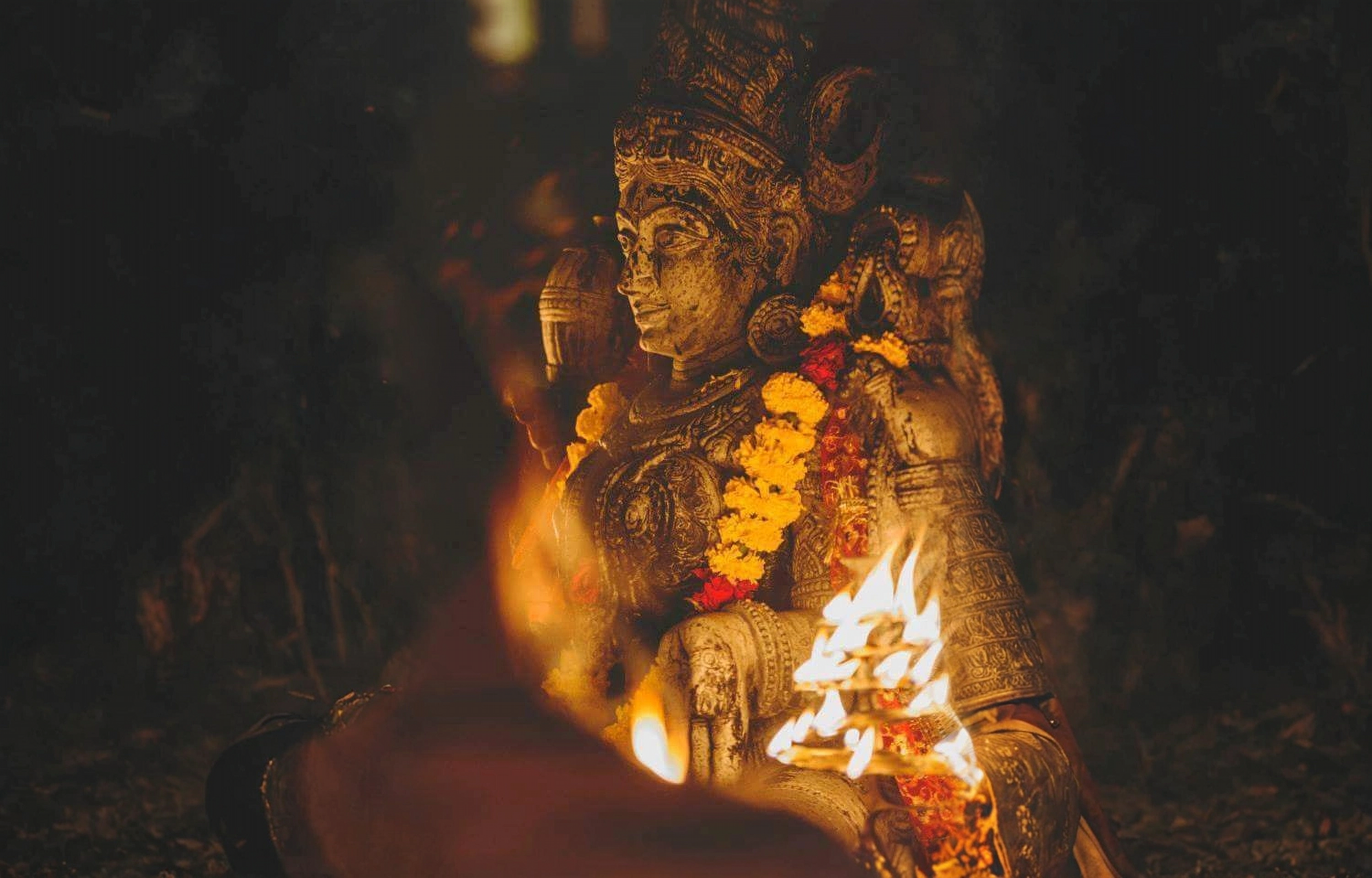 A fierce yet auspicious form of Kāli, venerated in South India, adorned with weapons and a crown, embodying divine