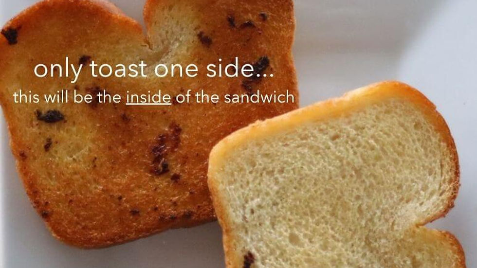 Two slices of sandwich bread, one visibly toasted and the other untoasted, displayed on a white plate with the text overlay "only toast one side… this will be the inside of the sandwich."