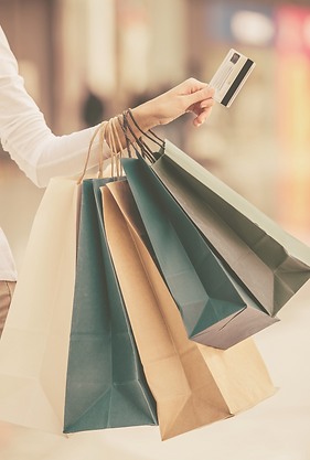 A woman holding shopping bags representing The Menopause Market selling peri, menopause and post menopause merchandise