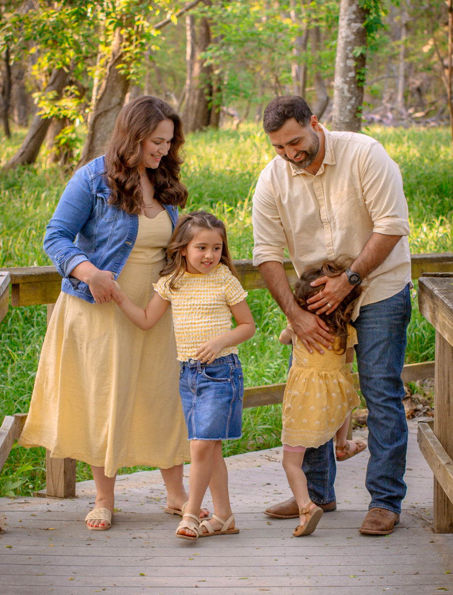 A mom and dad hug their children after they raced to see them.