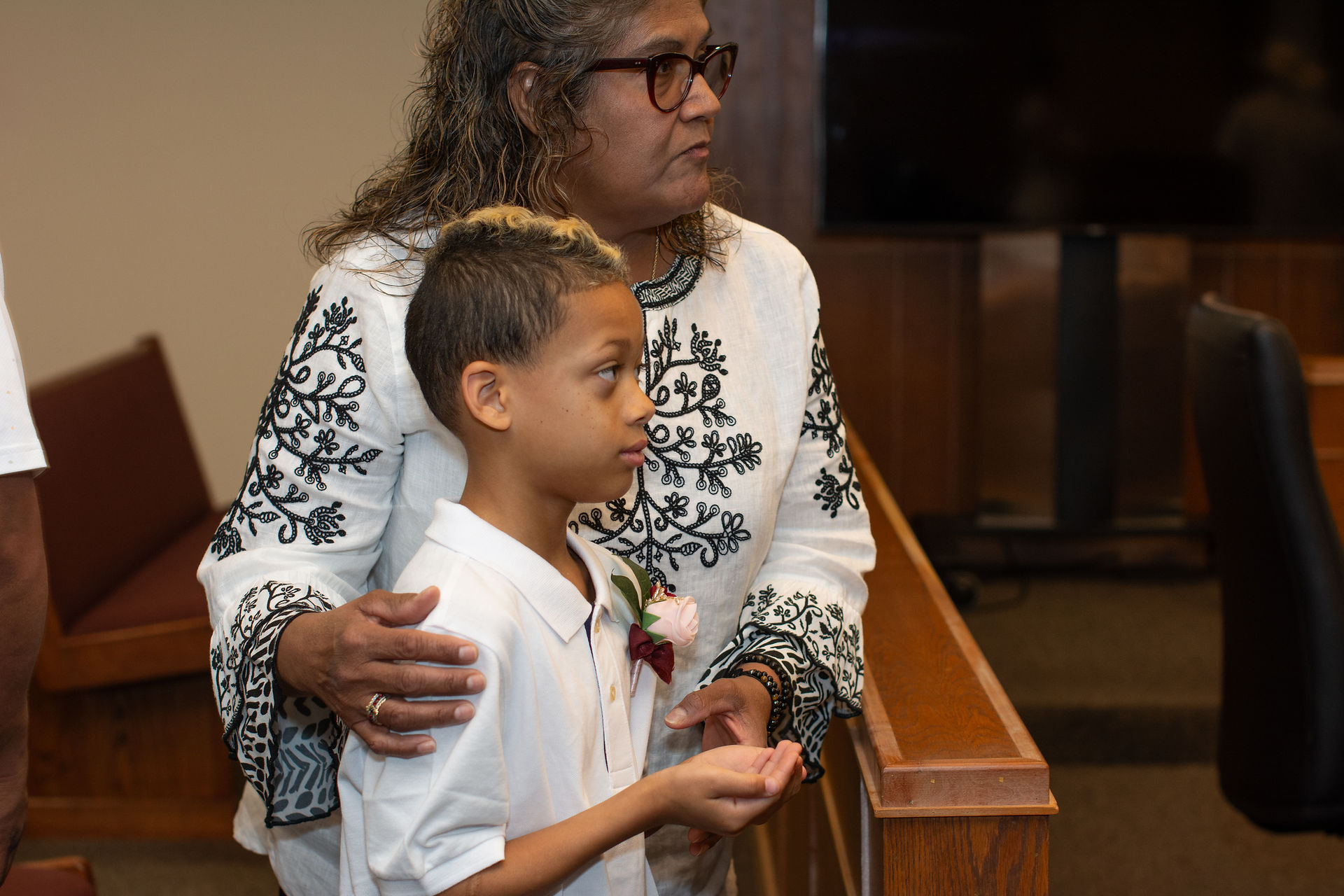 A ring bearer holds the rings in his hands at a courthouse wedding in Austin.