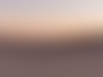 A photograph of a sand dune at sunset