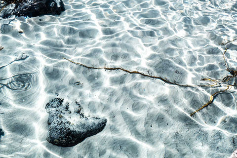 A photograph of a clear blue water beach