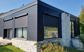 Motorized roll-up screens on patio enclosure for insect and UV protection