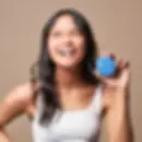 Smiling woman holding a small blue container