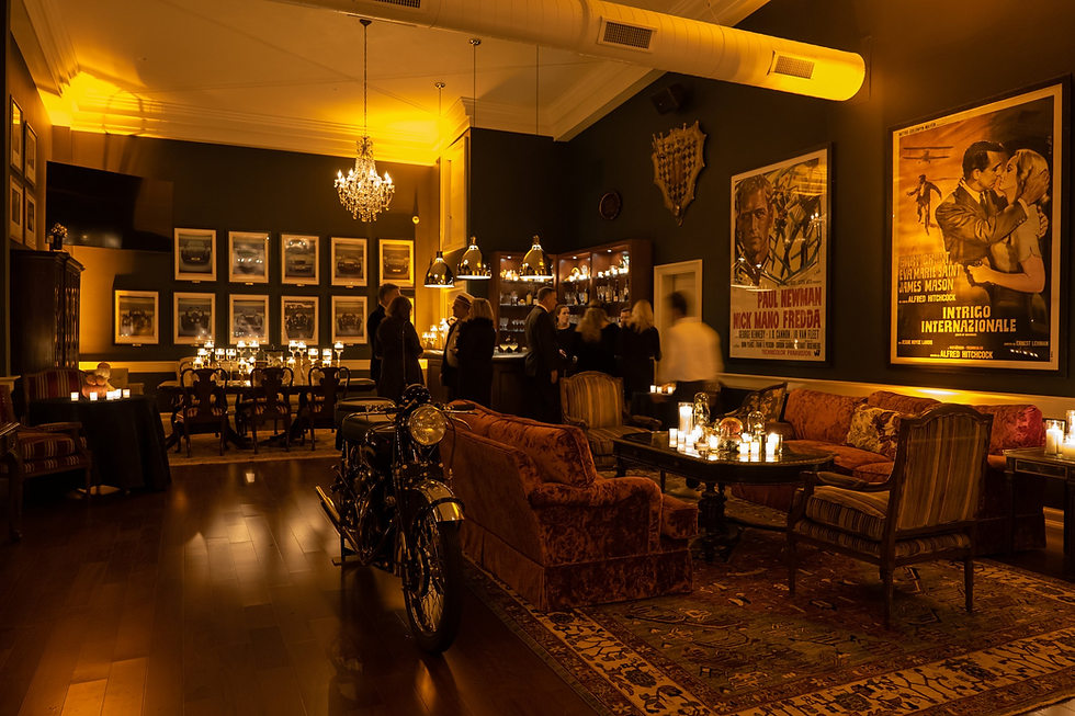 Private event dining set up surrounded by antique automobiles at The Vanderbilt Club