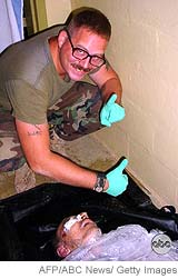 Cpl. Charles Graner with Iraqi prisoner who died at Abu Ghraib.