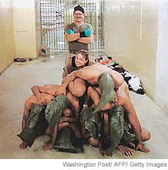 Cpl. Charles Graner and Spc. Sabrina Harman with detainees.