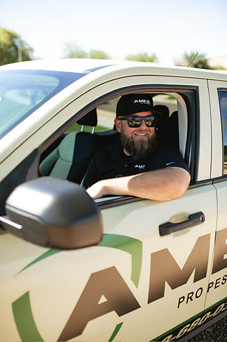 Ames Pro Pest Control technician in service truck providing pest control in Arizona