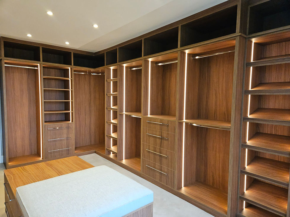 Walk-in wardrobe with island in walnut in Exeter.jpg