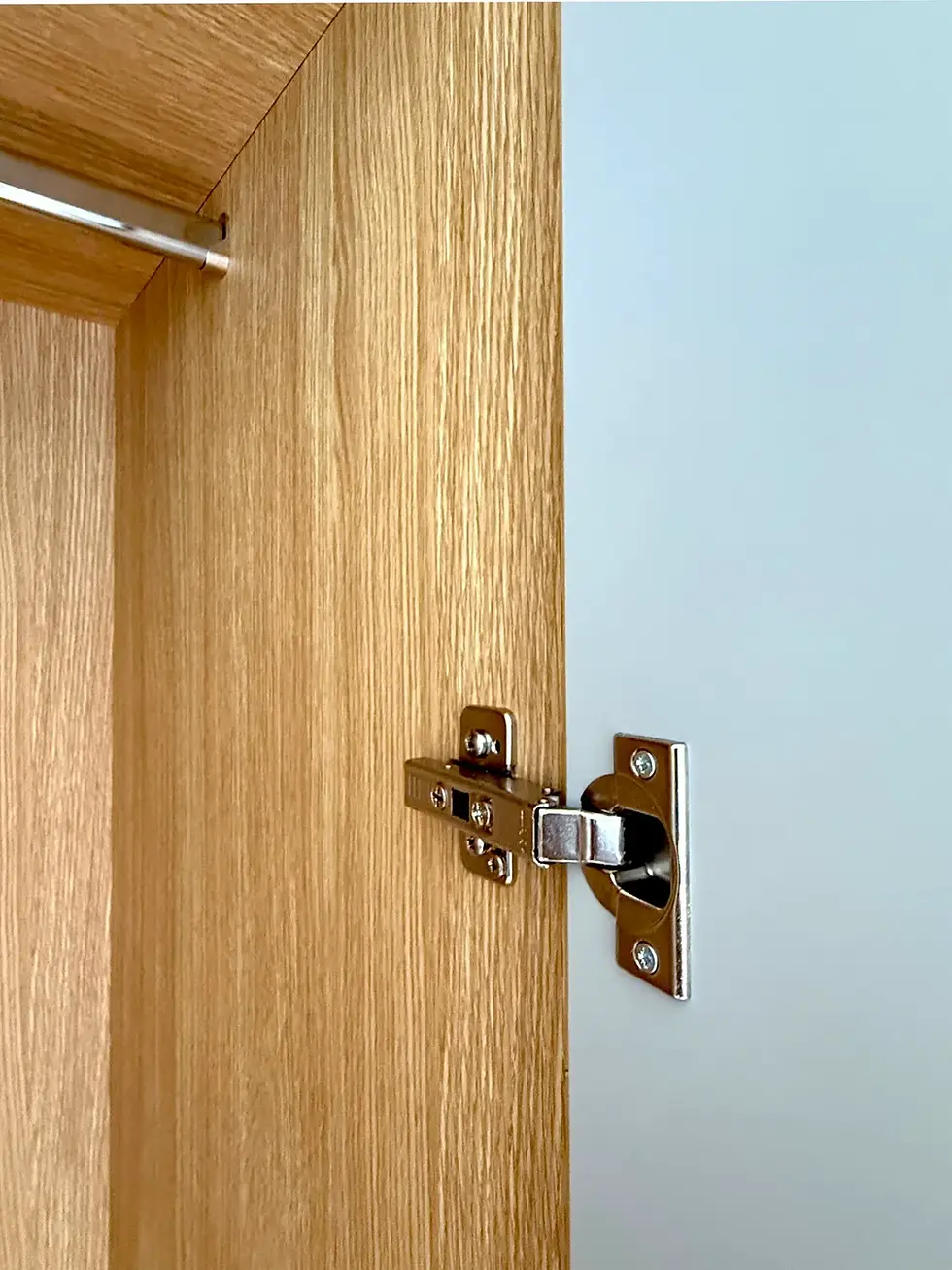 close up of wardrobe interior with oak veneer lining and linen effect doors