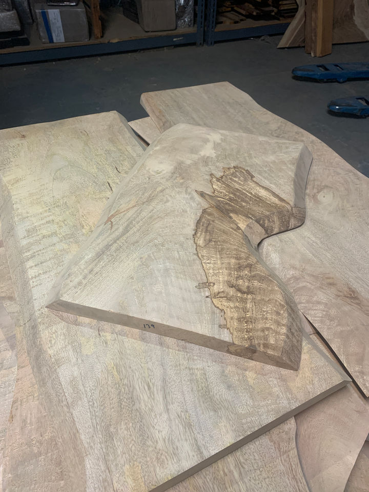 Wood pieces with unique shapes, likely for woodworking projects, Diamond Tropical Hardwoods.