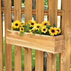teak planter box with sunflowers on fence 