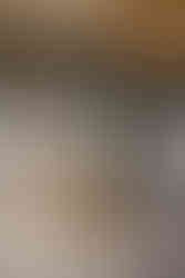 Circular design of an indoor wedding ceremony at Hidden Grove Estate in Williamston Michigan. Featuring elegant wooden chairs and the floral installation in the middle of the room. Best West Michigan Venues, Best Grand Rapids Photographers.