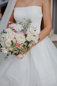 Detail of bridal bouquet and ball gown. Editorial photography at Bay pointe woods in Shelbyville, Michigan. West Michigan wedding photography.
