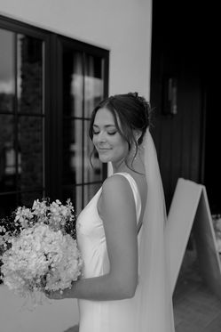 Black and white photo of bride with her bouquet. West Michigan Photographer.