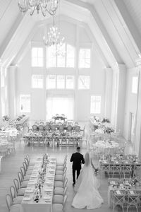 Black and white timeless photography at Etre Farms. Bride and groom doing a reception reveal, walking around their tables to look at florals, table settings, and seeing their vision come to life. Best West Michigan Photographers. Top 10 photographers in Grand Rapids.