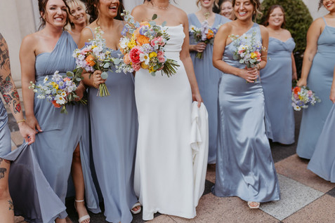 dusty blue bridesmaids dresses and colorful bouquets